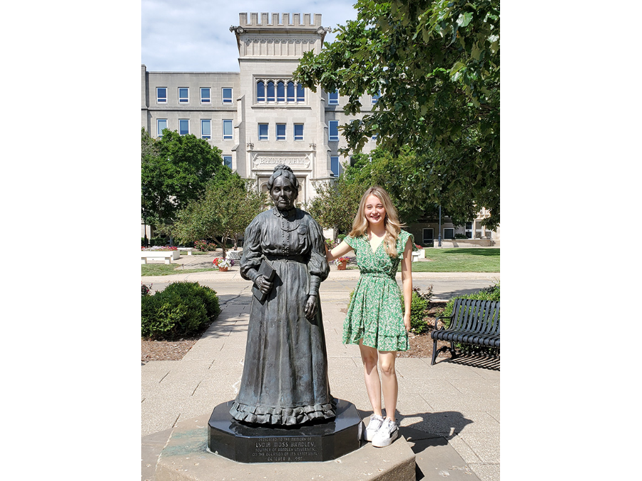 Yvonne Murphy standing next to Lydia Bradley's statue.