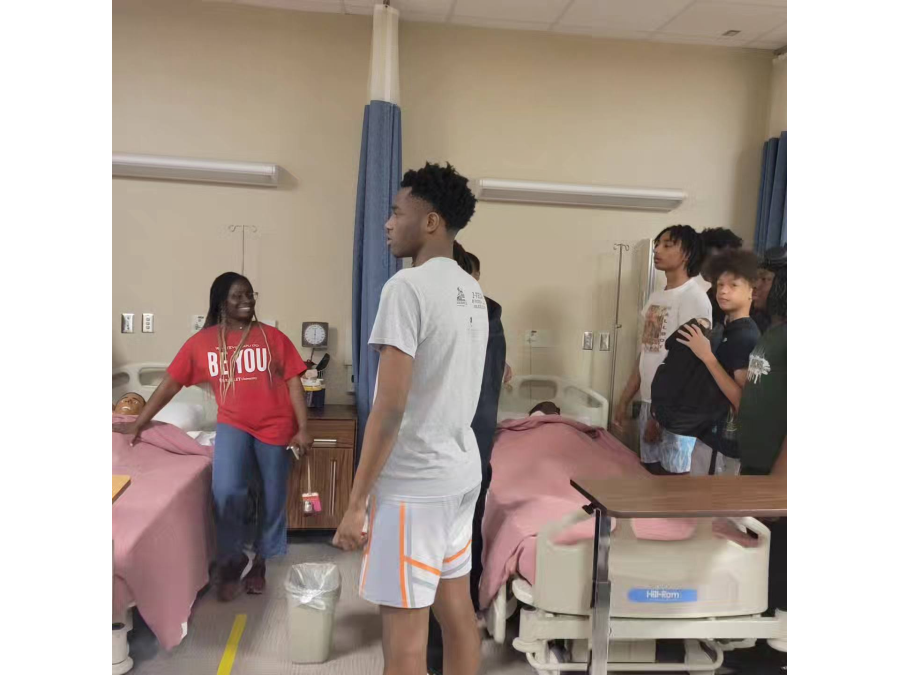 Dr. Sokonie Reed and GLOW students tour the Nursing simulation space.